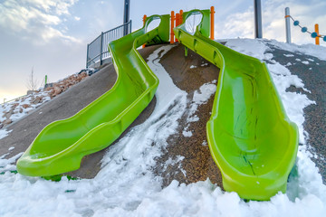 Double slides on a snow covered playground in Utah