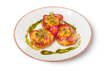 plate of bacon wrapped scallops in neat rows on a light colored plate