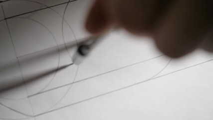 closeup constructor draws circle with compass on white paper - Powered by Adobe