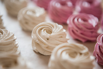 handmade marshmallows in pink and white are lying on the table in close-up. place for text, postcard