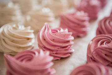 handmade marshmallows in pink and white are lying on the table in close-up. place for text, postcard