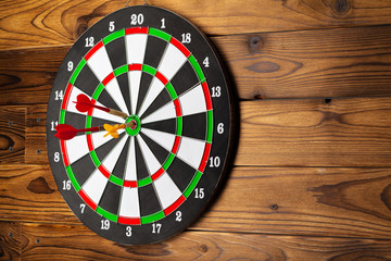 The darts on wooden background