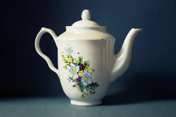 Porcelain teapot, white ceramic with color pattern for brewing tea.