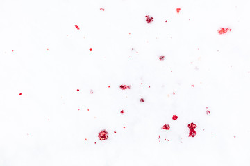 Red blood on white snow as a background