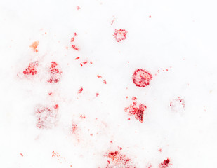 Red blood on white snow as a background