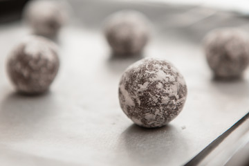 freshly baked chocolate cookies sprinkled with powdered sugar close-up