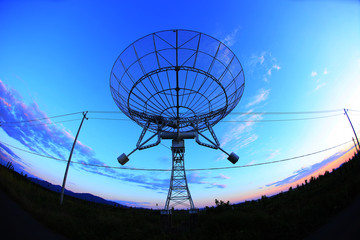 The silhouette of a radio telescope