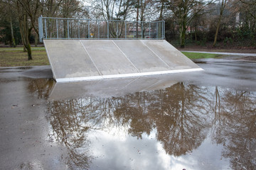 Empty skateboard ramp on a rainy day