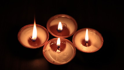 Four candles or butter lamps. Top view