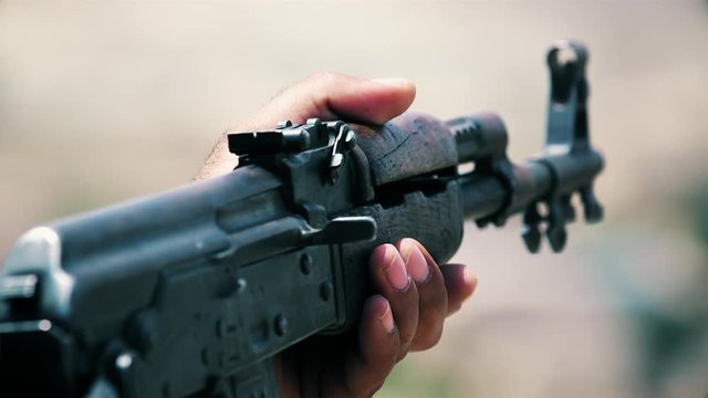 An army soldier holds a gun in his hand (AKM)