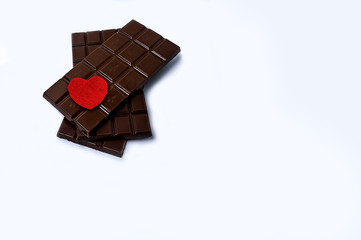 chocolate with a red heart on a white background close-up