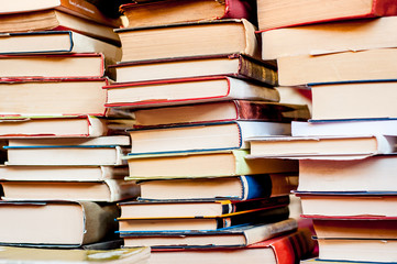 Stacked books background. Plies of books.