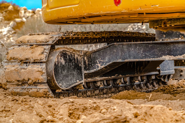 Fototapeta na wymiar Excavator with caked dirt on its track pad in Utah