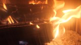 red flames of otgryaschih natural wood by the fireplace