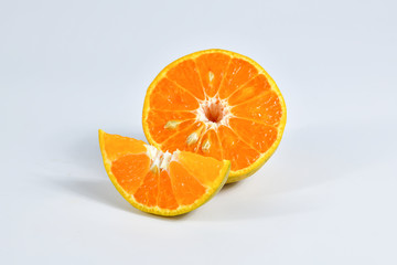 Half and slice of orange on white background.