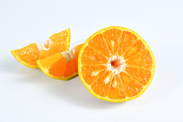 Half and slice of orange on white background.