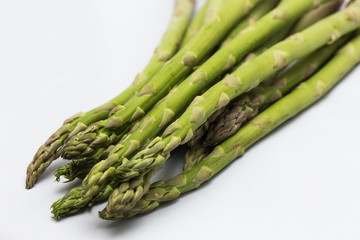 Close up of organic asparagus spears on a white background