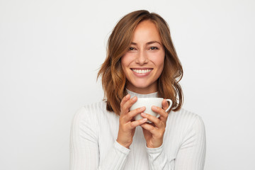 portrait of happy young woman with cup of coffee