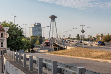 Obraz premium Daily traffic on the SNP bridge in the center of Bratislava, the capital of Slovak Republic