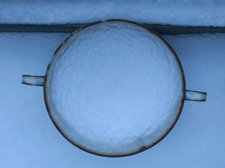 ice cup, bowl on a balcony filled with fresh snow