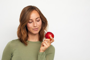 portrait of happy young woman with red apple