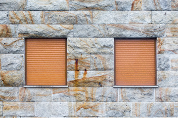 Old stone masonry wall covered with moss mountain gray.
