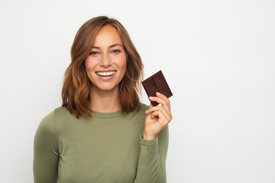 portrait of young happy woman with chocolate 