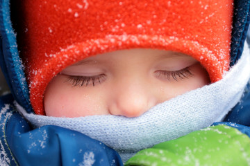 Little baby sleeping on the outdoor in a frosty day