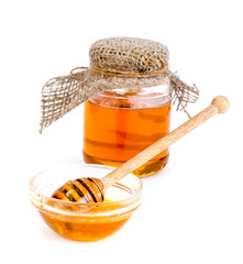 Glass jar with delicious fresh honey isolated on white background
