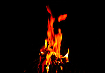 High flames in the fireplace on a black background