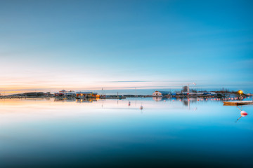 Helsinki, Finland. Landscape With City Pier, Jetty At Winter Sunrise Time.  Tranquil Sea Water Surface At Early Morning