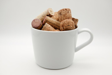 wine and champagne corks in a white mug