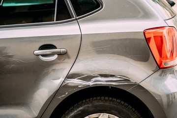 Broken Scratched Bumper Luxury Car Scratched With Deep Damage To Paint. Abandoned Car After Accident In Street