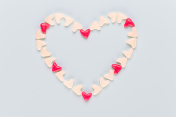 Valentines day background pastel hearts on blue wooden background.