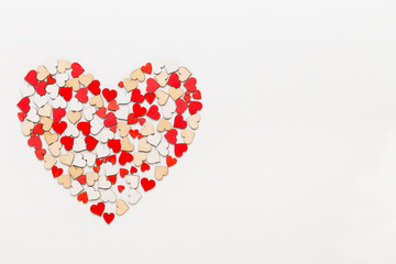 Valentines day background red hearts on white wooden background.