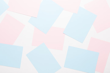 Abstract geometric background in light pastel tones from sheets of thick pale past paper.