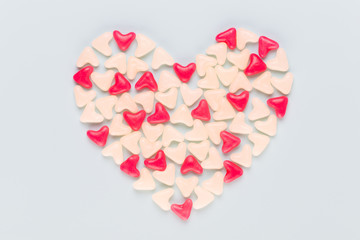 Valentines day background pastel hearts on blue wooden background.