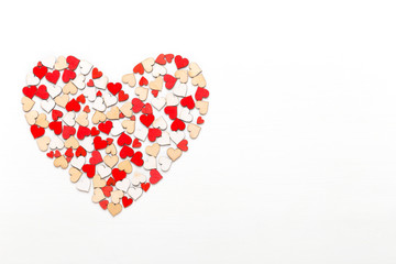 Valentines day background red hearts on white wooden background.