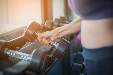 Obraz premium fitness woman doing exercises and warm up at gym ; healthy lifestyle