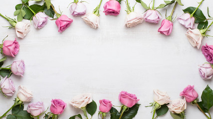 Flowers valentine day composition. Frame made of pink rose on gray background. Flat lay, top view, copy space.