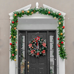 Fototapeta na wymiar Glass paned front door with garland and wreath