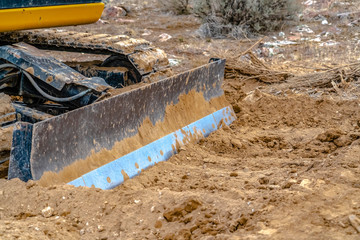 Grader blade attached to excavator in Utah Valley