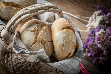 Roll breads in basket on table.