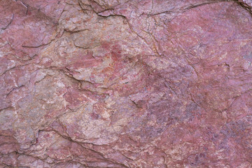 Stone texture background with unique pattern. Pink rock texture. Rock surface abstract background. Natural stone background. Purple rough stone floor. Grunge and rust rock texture.