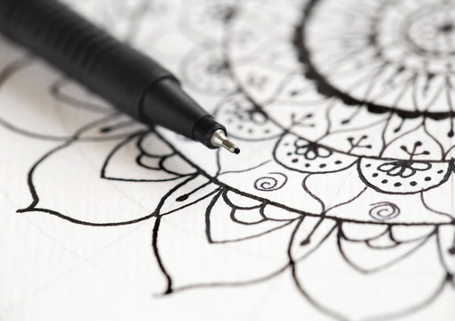 Mandala doodle hand drawing with pen, black and white