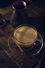 Cup of black coffee on the table with cream
