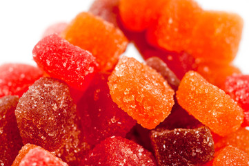 Red, yellow and orange jelly candies shot close up on a white background