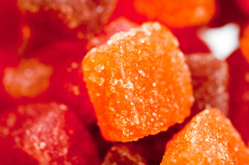 Red, yellow and orange jelly candies shot close up on a white background