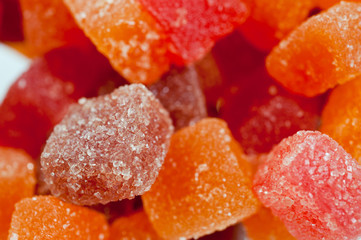 Red, yellow and orange jelly candies shot close up on a white background