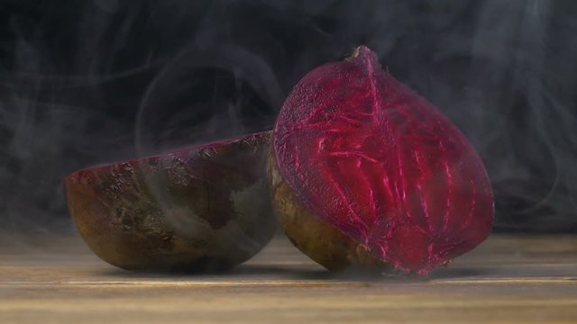 beetroot garden beet is on the table in cold, steam from frost in slow motion, cloese up